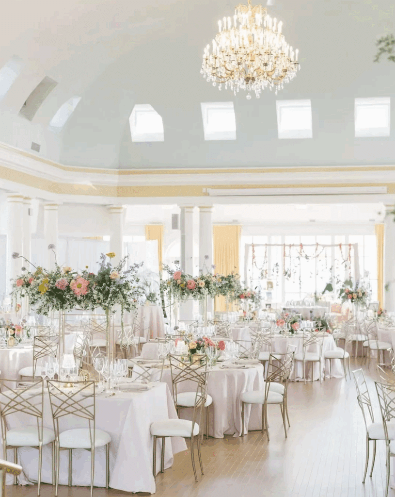 Spring wedding reception setup featuring gold chameleon chairs.